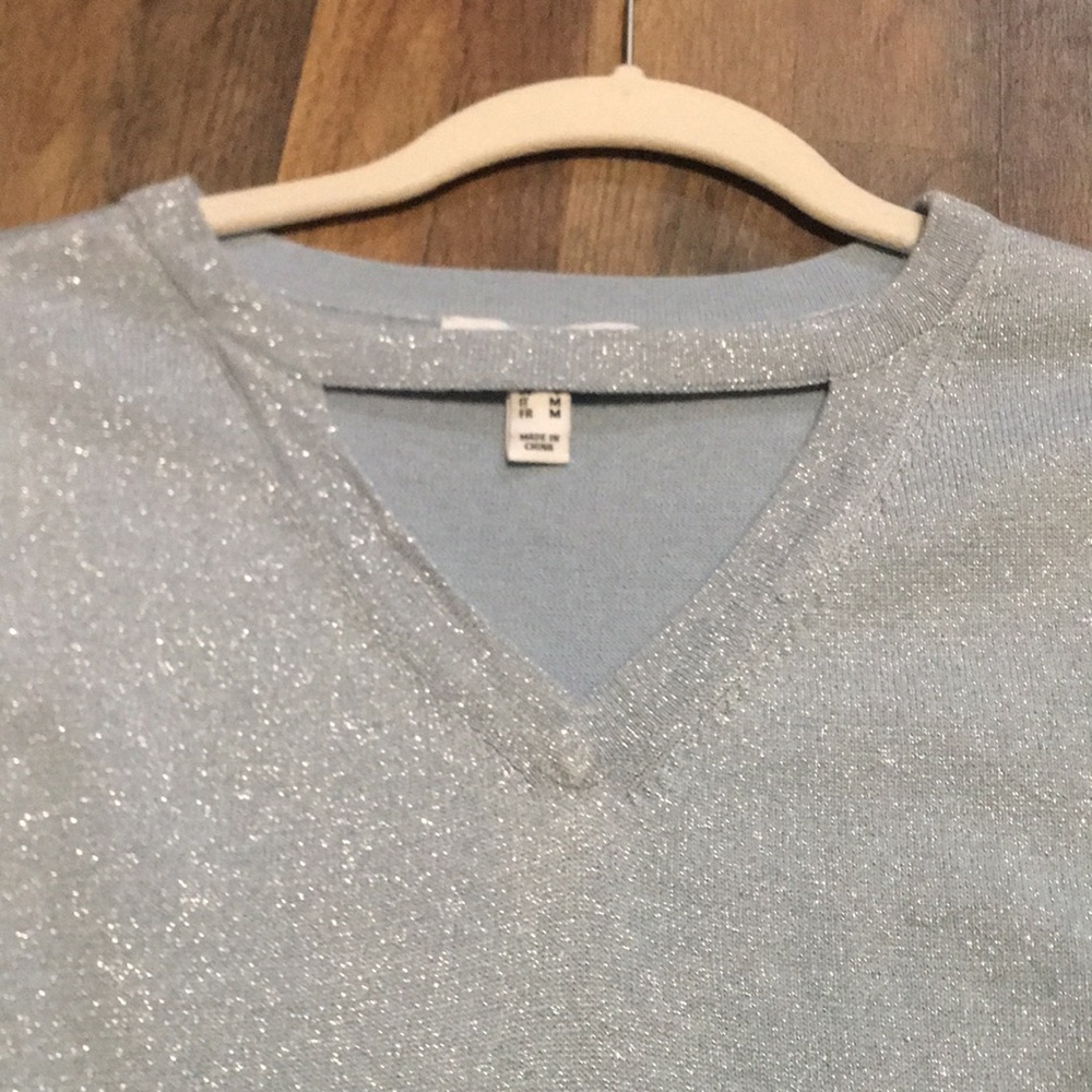 Sparkle! V neck with design at the neck.